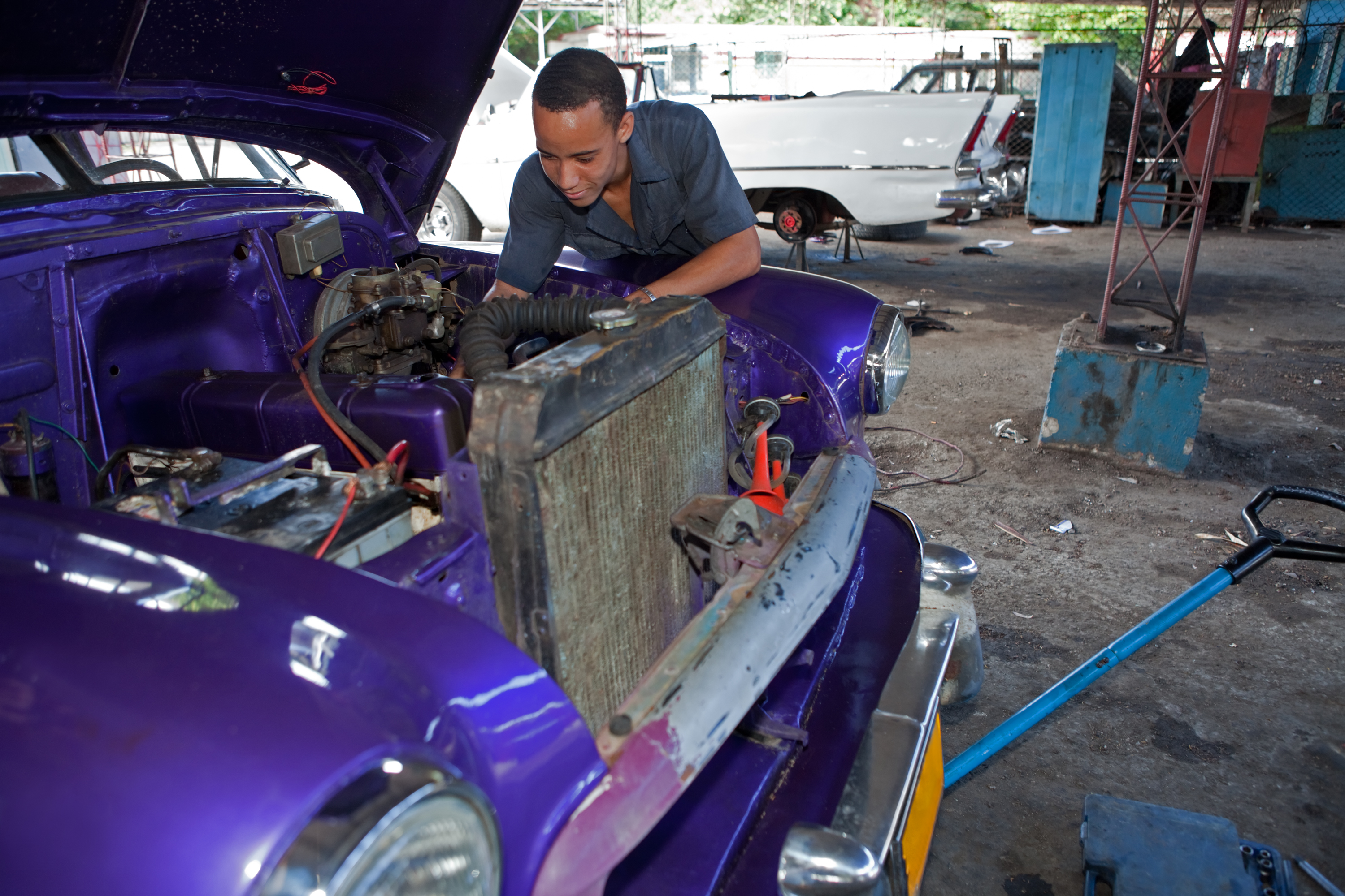 An auto mechanic, working on an automobile